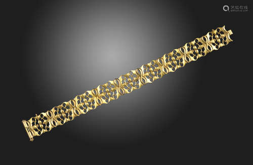 A gold bracelet by Carlo Giuliano, of foliate design with pierced and polished yellow gold links,