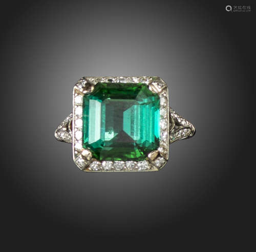 An Art Deco tourmaline and diamond cluster ring, the Asscher-cut tourmaline is set within a surround