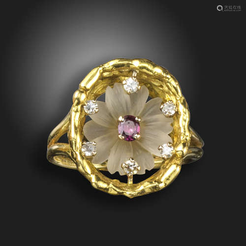 A gem-set flowerhead ring by John Donald, the rock crystal flower set with a ruby centre within an