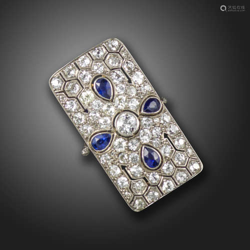 A sapphire and diamond rectangular plaque ring, pierced and decorated with pear-shaped sapphires and