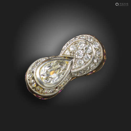 A diamond and ruby mounted cluster ring, the pear-shaped diamond weighs approximately 1.30cts, the