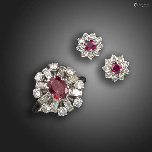 A ruby and diamond ring and earring set, the ring centred with an oval-shaped ruby within a surround