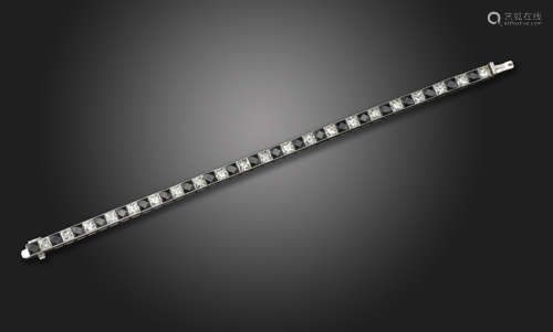 A diamond and black onyx line bracelet, alternately-set with French-cut diamonds and black onyx