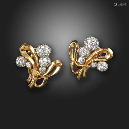 A pair of diamond and gold scroll earrings, c.1950, the pave-set diamond semi-spheres set within