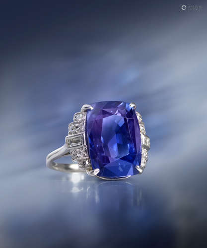 A cushion-shaped colour change sapphire and diamond ring, set with graduated circular and baguette-