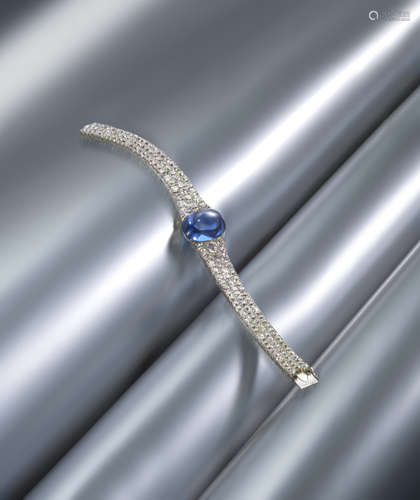 An Art Deco sapphire and diamond bracelet, centred with an oval cabochon sapphire, the bracelet