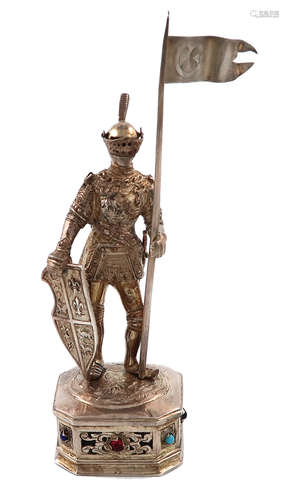 A German silver-gilt model of a knight, modelled in a standing position holding a lance and