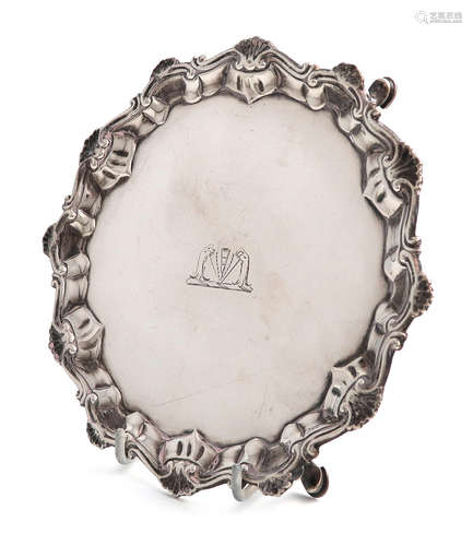 A George III silver waiter, by Richard Rugg, London 1764, circular form, shell and scroll border, on