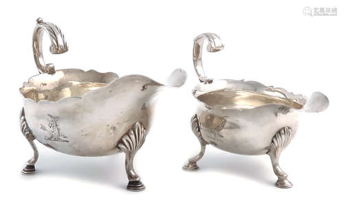 A George II silver cream boat, by David Hennell, London 1754, oval form, wavy-edge border, leaf