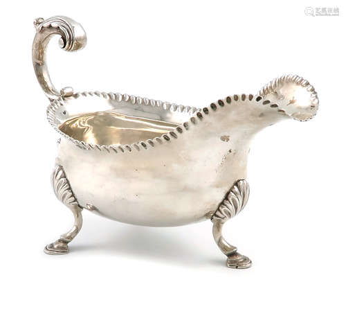 A George III silver sauce boat, probably by William Skeen, London 1765, oval form, leaf capped