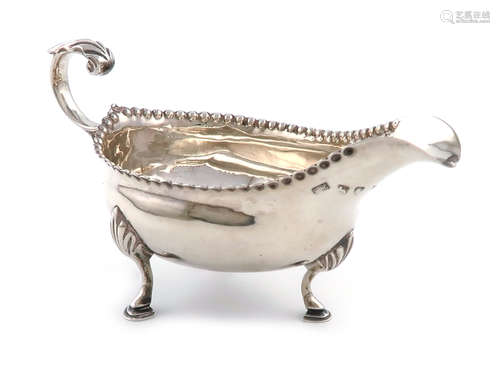 A George III silver cream boat, by Hester Bateman, London 1788, oval form, punch-bead border, leaf-