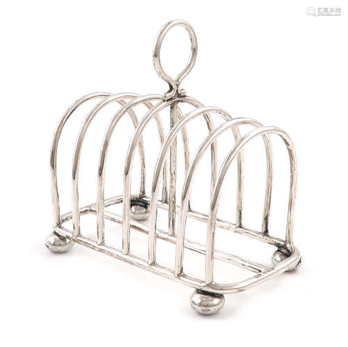 An Edwardian silver seven-bar toast rack, by William Aitken, Birmingham 1905, rounded rectangular