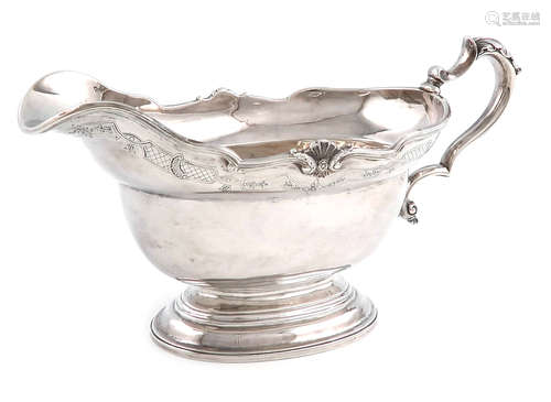 A silver sauce boat, by Charles Stuart Harris, London 1920, oval form, scroll and shell border, with