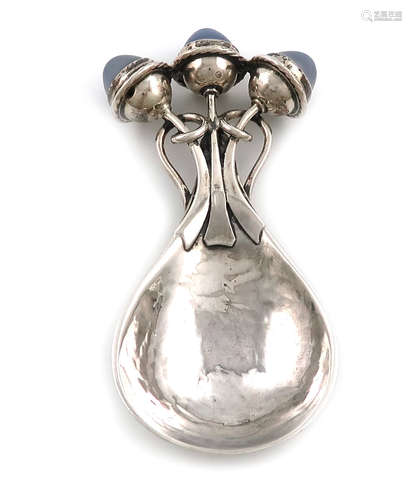 By Omar Ramsden and Alwyn Carr, an Arts and Crafts silver caddy spoon, London 1914, spot-hammered