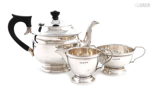 A matched three-piece silver tea set, the teapot by E. Viner, Sheffield 1935, the cream and sugar by