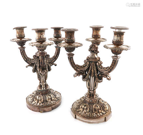 A pair of French electroplated candelabra, with three scroll arms with swags and foliate mounts,