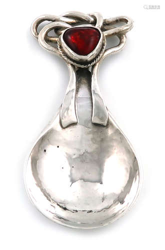 By Omar Ramsden, an Arts and Crafts silver caddy spoon, London 1921, spot-hammered fig-shaped