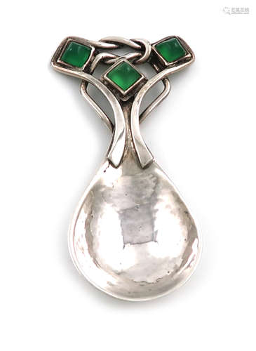 By Omar Ramsden, an Arts and Crafts silver caddy spoon, London 1935, spot-hammered fig-shaped