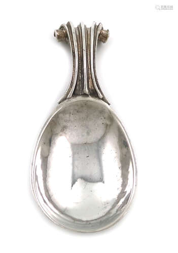 By Omar Ramsden, an Arts and Crafts silver caddy spoon, London 1927, spot-hammered bowl, fluted