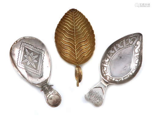 A small collection of three antique silver caddy spoons, comprising: a silver-gilt one of leaf form,