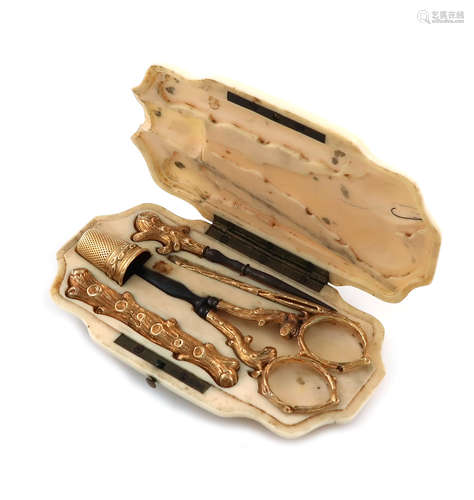 λA 19th century French ivory and gold sewing case, shaped rectangular form, the hinged cover opens