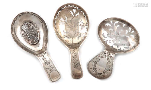 A small collection of three antique silver caddy spoons, all with oval bowls, pierced decoration and