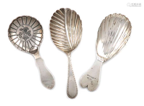 A small collection of three antique Irish and Scottish silver caddy spoons, comprising: one by