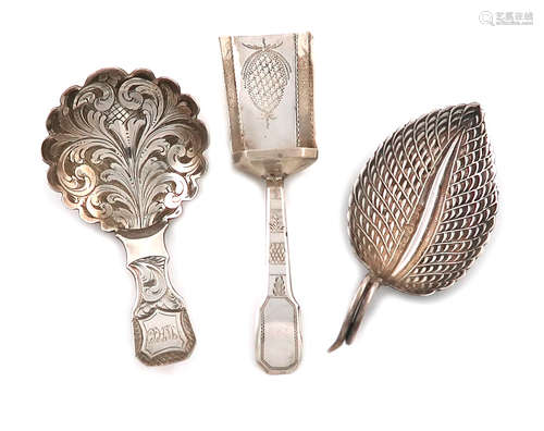 A small collection of three antique silver caddy spoons, comprising: one of leaf form, by Matthew