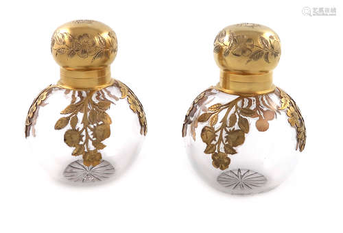 A pair of Victorian silver-gilt mounted glass scent bottles, by George Heath, London 1890,