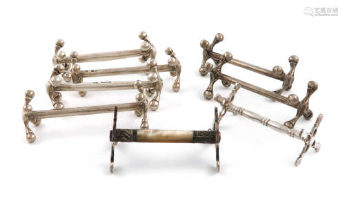 A collection of eight silver knife rests, comprising: a Victorian pair, by Atkin Bros, Sheffield