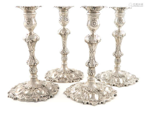 A set of four George II silver cast candlesticks, by William Gould, London 1749, baluster columns,