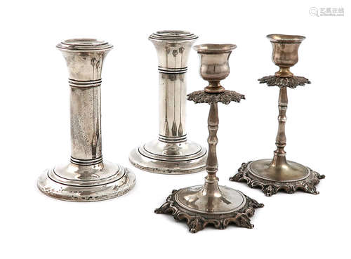 A pair of dwarf silver candlesticks, by The Boots Pure Drug Company, Birmingham 1919, circular