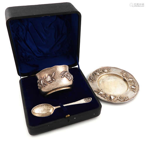 A three-piece Edwardian Arts and Crafts silver-gilt christening set, by Nathan and Hayes, Chester