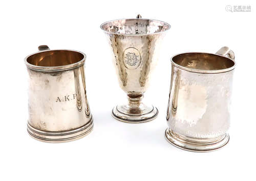 A collection of three silver christening mugs, comprising: an Arts and Crafts one, by Arnold &