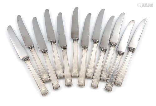 A set of twelve Japanese silver-handled dessert knives, the handles of tapering rectangular form,