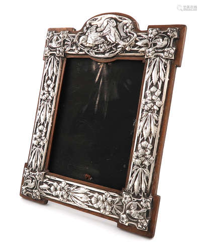 An Edwardian silver photograph frame, by J Aitkin & Son, Birmingham 1904, shaped upright rectangular