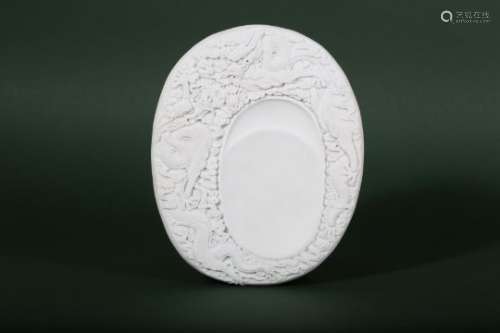 A CHINESE WHITE BISCUIT 'DRAGON' INKSTONE.