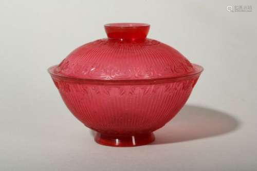 A CHINESE PEKING GLASS RUBY RED TEA BOWL AND COVER.