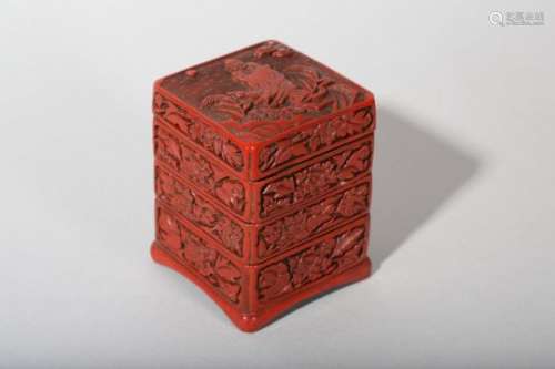 A CHINESE CINNABAR LACQUER THREE-TIERED BOX AND COVER.