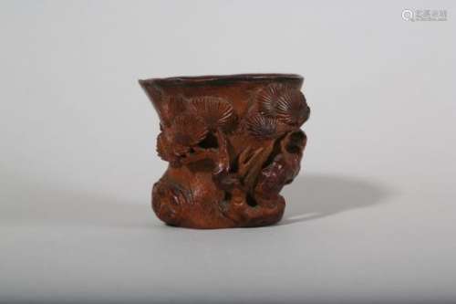 A CHINESE CARVED BAMBOO 'PINE TREE' LIBATION CUP.