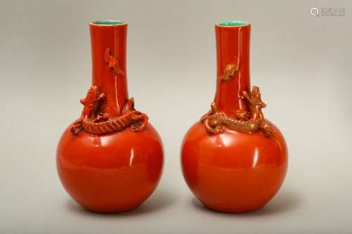 A PAIR OF SALMON RED-GLAZED 'DRAGON' VASES.