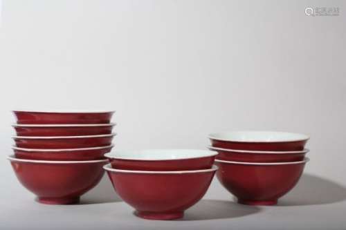 A SET OF TEN CHINESE COPPER RED-GLAZED BOWLS.