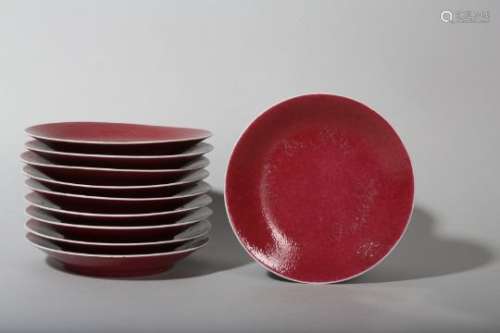 A SET OF TEN CHINESE COPPER RED-GLAZED DISHES.