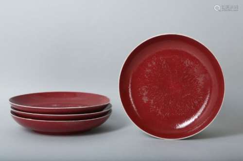 A SET OF FOUR CHINESE COPPER RED-GLAZED DISHES.