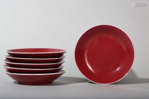 A SET OF SIX CHINESE COPPER-RED GLAZED SAUCER DISHES.