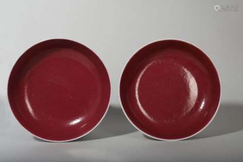 A PAIR OF CHINESE COPPER RED GLAZED DISHES.