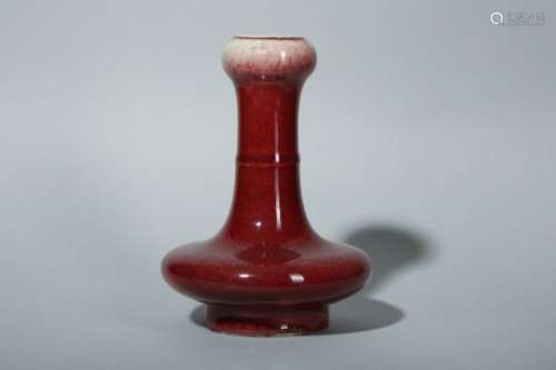 A CHINESE COPPER RED-GLAZED GARLIC NECKED VASE.