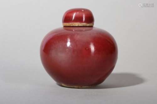 A SMALL CHINESE COPPER RED-GLAZED JAR AND COVER.