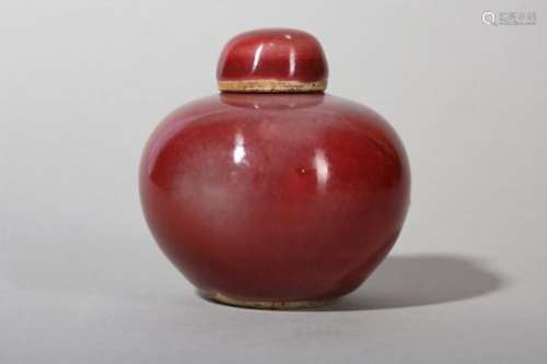 A SMALL CHINESE COPPER RED-GLAZED JAR AND COVER.