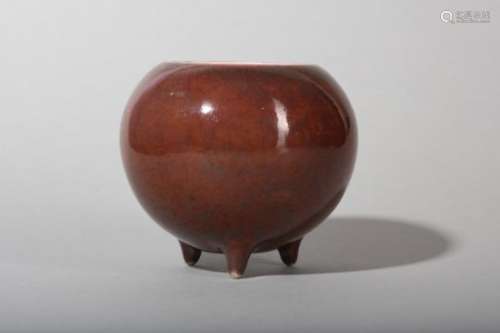 A CHINESE COPPER RED-GLAZED TRIPOD WATER POT.